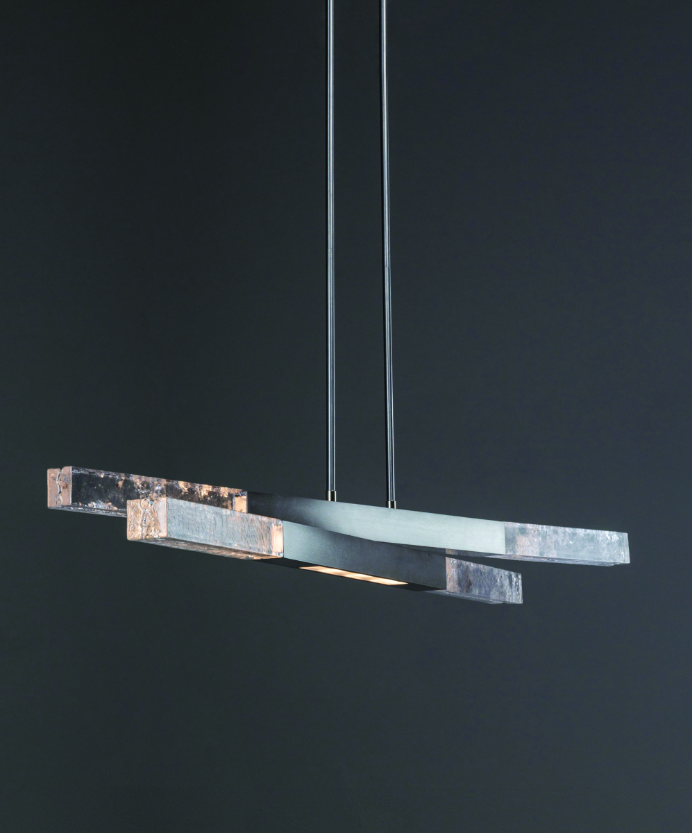 Glacier Linear Suspension :: Hammerton StudioWhat’s noteworthy: An inventive – and beautiful – use for upcycling discarded glass.Salvaged material from the company’s domestic glass production is repurposed in LED-lit artisan cast glass and paired with hand-polished metalwork. Three downlights provide additional task lighting.“This light expresses my fascination with the use of restraint in design,” says Levi Wilson, Hammerton founder and VP/Design. “Restraint makes thoughtful use of only the necessary elements to achieve a desired effect. It’s a vastly more disciplined design approach than Minimalism, which is typically achieved by minimizing excess.”The Glacier linear suspension is offered in 2 sizes and 8 finishes. www.hammerton.com